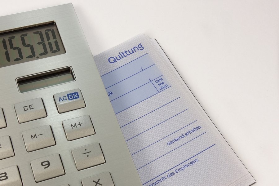 An invoice beside a calculator